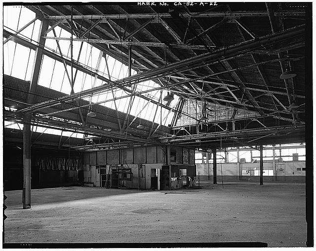 Ford Long Beach Assembly Plant TIME CLOCK AREA, WITH LUNCH ROOM IN DISTANCE. RAIL SPUR FOLDING DOORS ARE HIDDEN BEHIND OFFICE AT PHOTO CENTER. VIEW TO EAST-NORTHEAST. 
