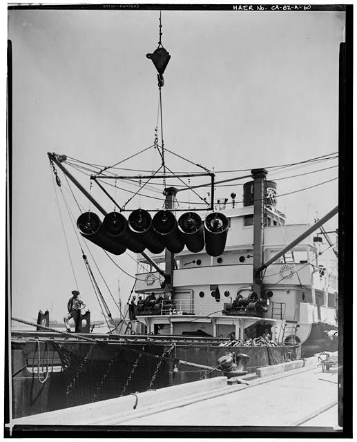 Ford Long Beach Assembly Plant Jun 24, 1930, EXTERIOR-WAREHOUSE, WHEEL SLING ON THE LOADING DOCK AND FORD SHIP
