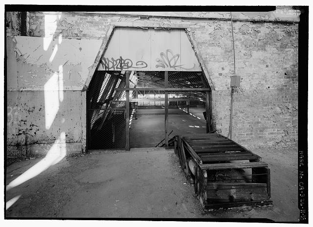 Ford Richmond Assembly Plant VIEW TO EAST, DETAIL OF OPENING THROUGH THE SECOND FLOOR EAST WALL SHOWING CONVEYOR FOR MOVING MATERIAL TO THE SECOND FLOOR. (NOTE: THIS IS NOT AN ORIGINAL CONVEYOR FOR MOVING BODY PARTS).